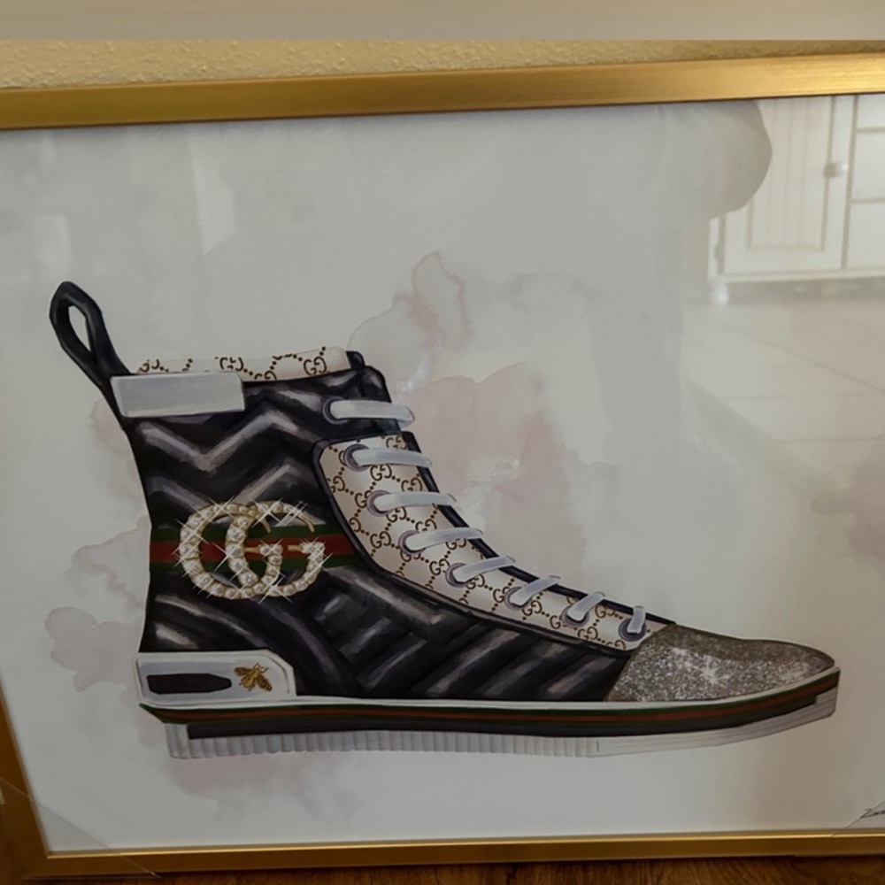 Brand new. Gucci sneaker wall art. Size is 20" L x 16" H. Gold frame.